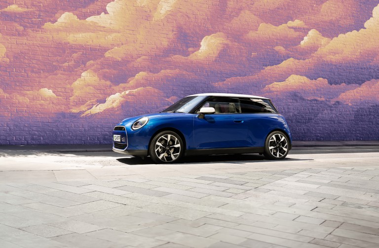  all-electric MINI Cooper parked by building