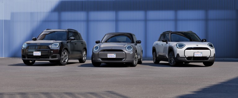 Electric MINI Cooper, Electric MINI Aceman and Electric MINI Countryman in a business parking lot